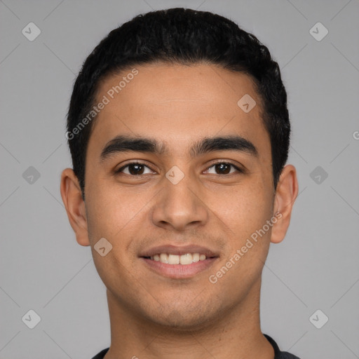 Joyful latino young-adult male with short  black hair and brown eyes