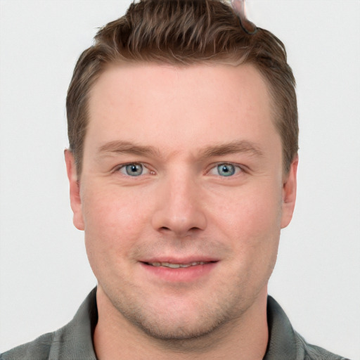 Joyful white young-adult male with short  brown hair and blue eyes