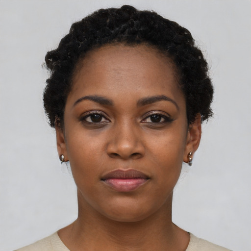 Joyful black young-adult female with short  black hair and brown eyes