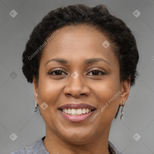 Joyful black adult female with short  brown hair and brown eyes