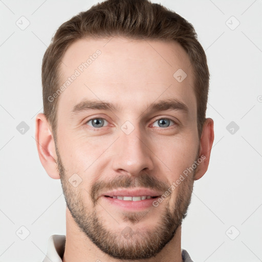 Joyful white young-adult male with short  brown hair and grey eyes