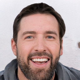 Joyful white young-adult male with short  black hair and brown eyes