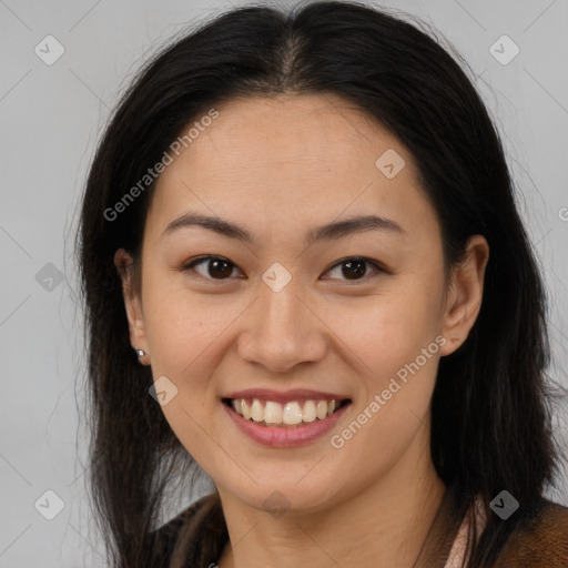 Joyful latino young-adult female with long  brown hair and brown eyes