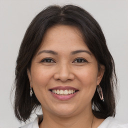 Joyful white adult female with medium  brown hair and brown eyes