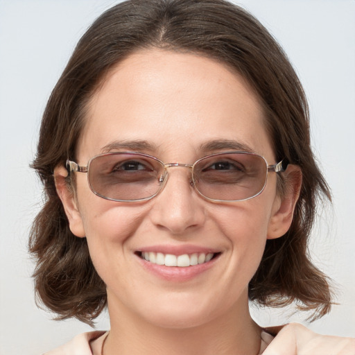 Joyful white young-adult female with medium  brown hair and blue eyes