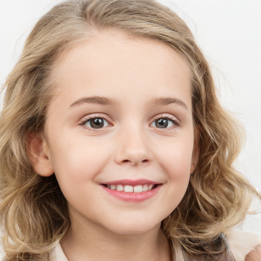 Joyful white child female with long  brown hair and blue eyes