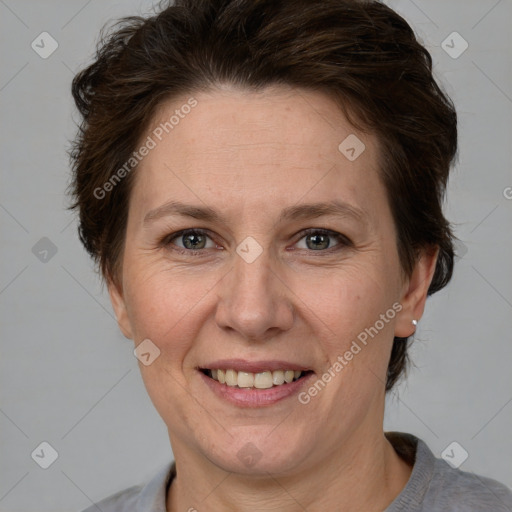 Joyful white adult female with short  brown hair and grey eyes