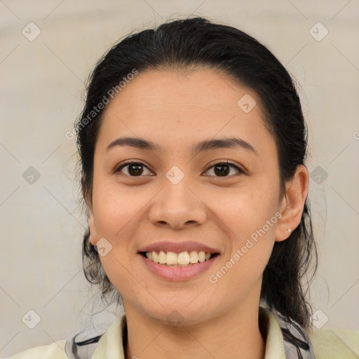 Joyful latino young-adult female with medium  brown hair and brown eyes