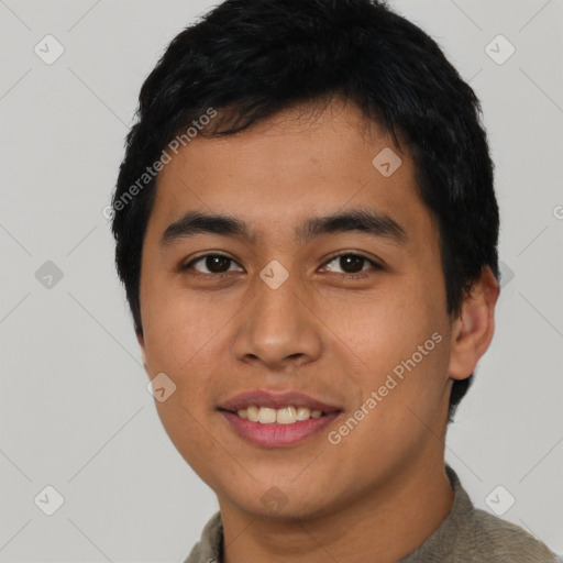 Joyful asian young-adult male with short  black hair and brown eyes