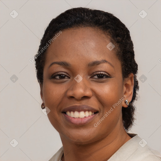 Joyful black young-adult female with short  black hair and brown eyes