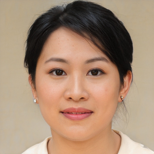 Joyful asian young-adult female with medium  brown hair and brown eyes