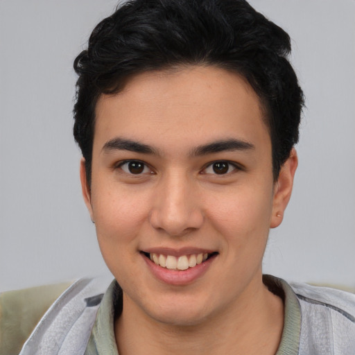 Joyful latino young-adult male with short  brown hair and brown eyes