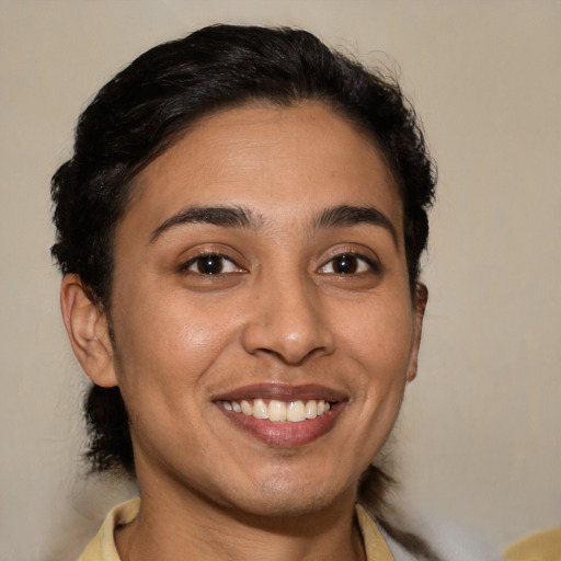 Joyful latino young-adult female with medium  brown hair and brown eyes