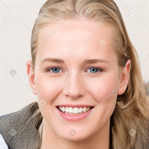 Joyful white young-adult female with long  brown hair and blue eyes