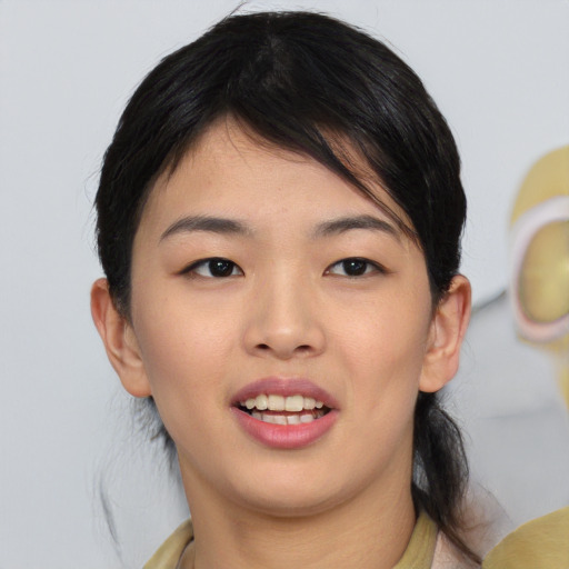 Joyful asian young-adult female with medium  black hair and brown eyes