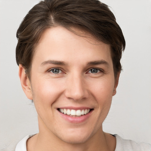 Joyful white young-adult female with short  brown hair and brown eyes