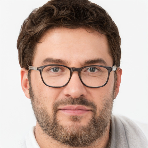 Joyful white adult male with short  brown hair and brown eyes