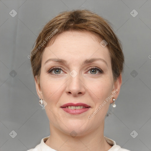 Joyful white young-adult female with short  brown hair and grey eyes