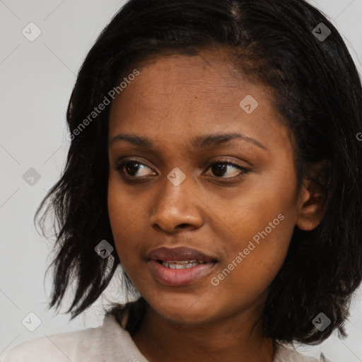 Joyful black young-adult female with medium  black hair and brown eyes