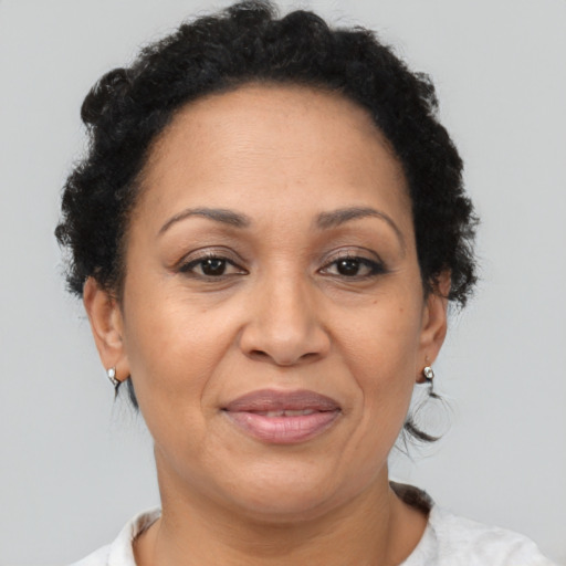 Joyful latino adult female with short  brown hair and brown eyes