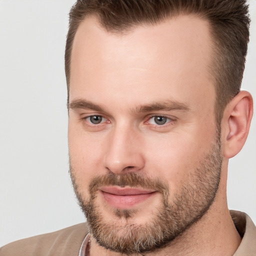 Joyful white adult male with short  brown hair and brown eyes