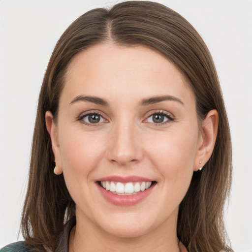 Joyful white young-adult female with long  brown hair and grey eyes