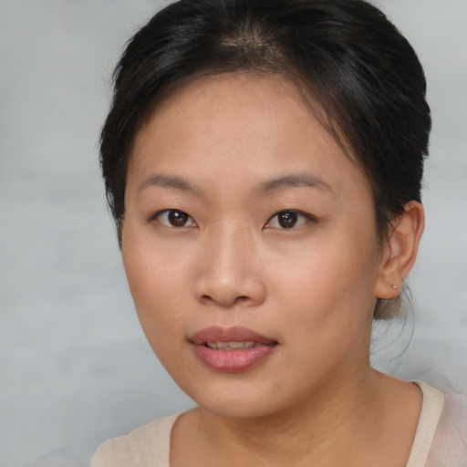 Joyful asian young-adult female with short  brown hair and brown eyes