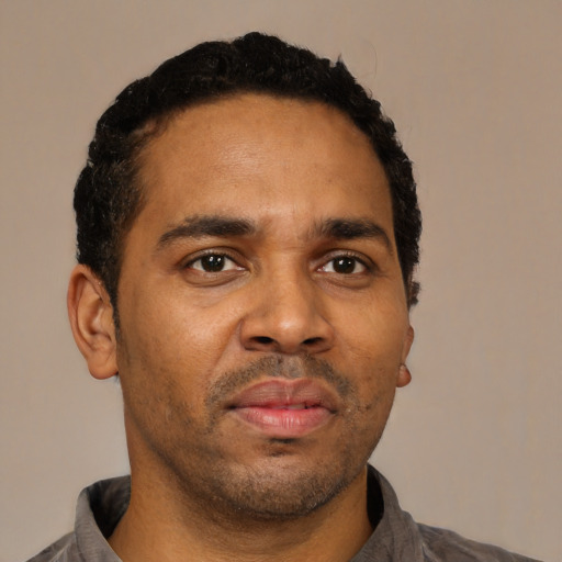Neutral latino adult male with short  black hair and brown eyes