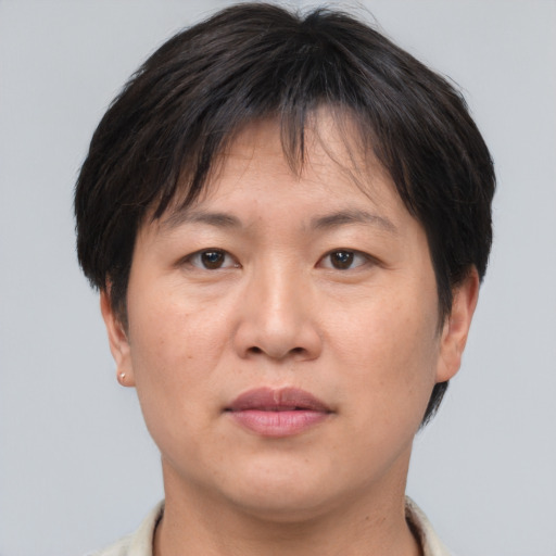 Joyful asian adult female with short  brown hair and brown eyes