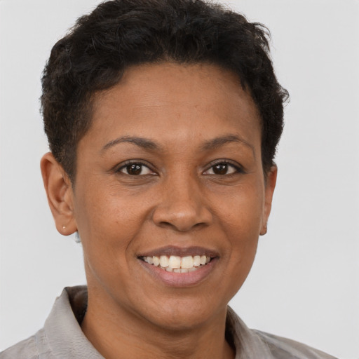 Joyful latino adult female with short  brown hair and brown eyes