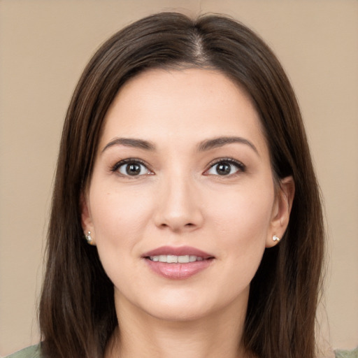 Joyful white young-adult female with long  brown hair and brown eyes