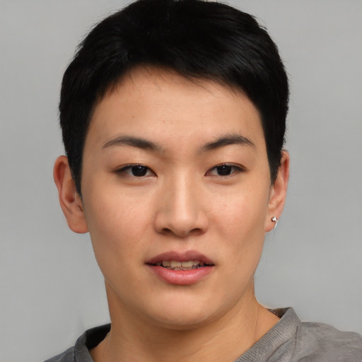 Joyful asian young-adult female with short  black hair and brown eyes
