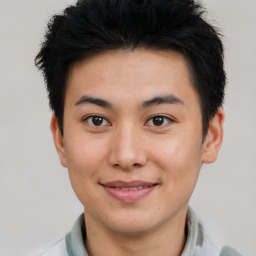 Joyful asian young-adult male with short  brown hair and brown eyes