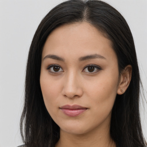 Joyful asian young-adult female with long  brown hair and brown eyes