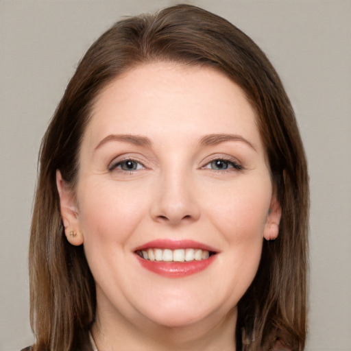 Joyful white young-adult female with long  brown hair and grey eyes