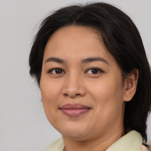 Joyful asian adult female with medium  brown hair and brown eyes
