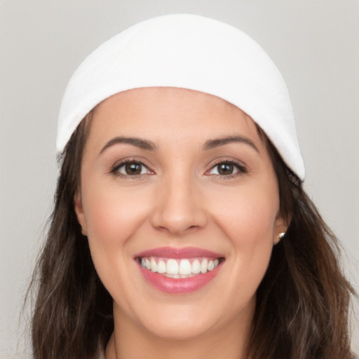 Joyful white young-adult female with long  brown hair and brown eyes