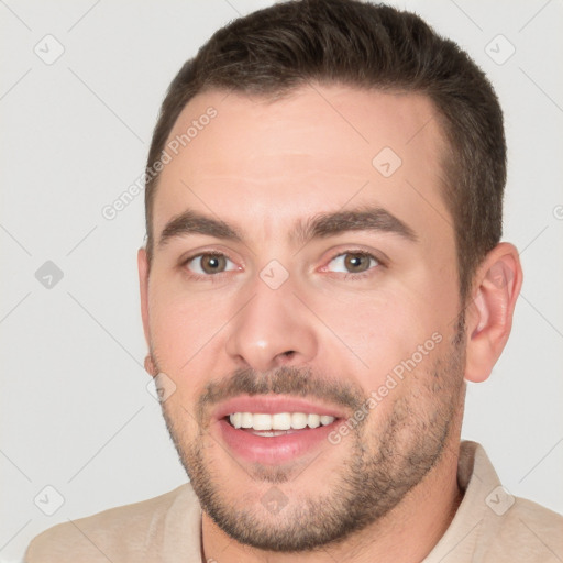 Joyful white young-adult male with short  brown hair and brown eyes