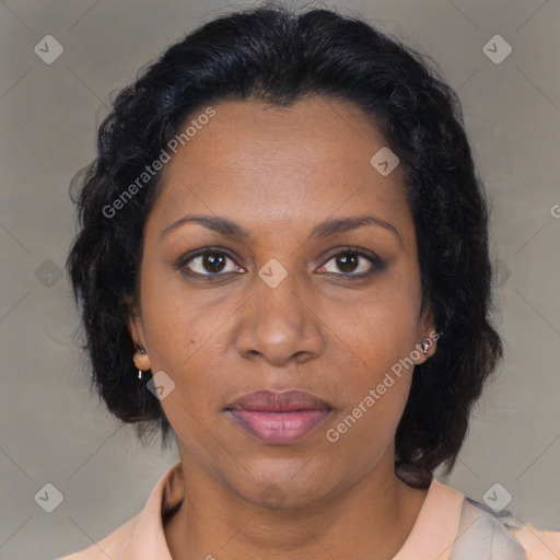 Joyful black adult female with medium  brown hair and brown eyes