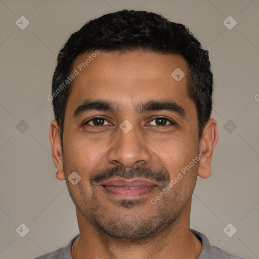 Joyful latino young-adult male with short  black hair and brown eyes