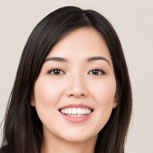 Joyful white young-adult female with long  black hair and brown eyes