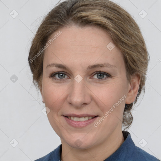 Joyful white adult female with medium  brown hair and grey eyes