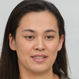 Joyful white young-adult female with long  brown hair and brown eyes