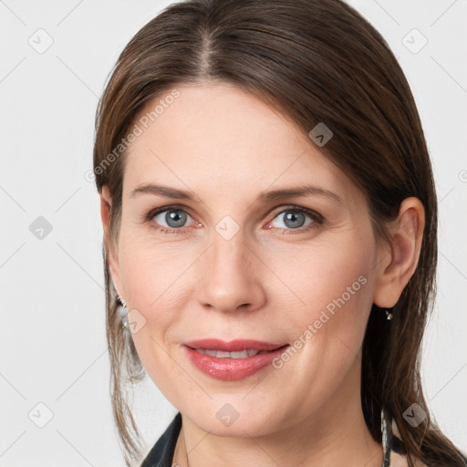 Joyful white young-adult female with medium  brown hair and grey eyes