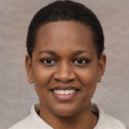 Joyful black young-adult female with short  black hair and brown eyes