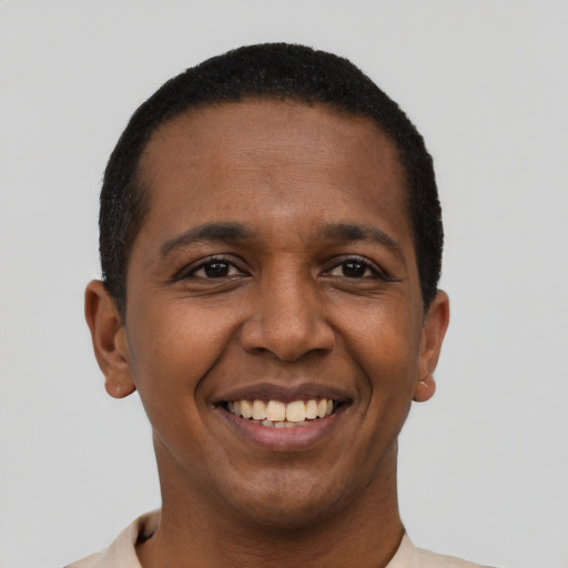 Joyful black young-adult male with short  black hair and brown eyes
