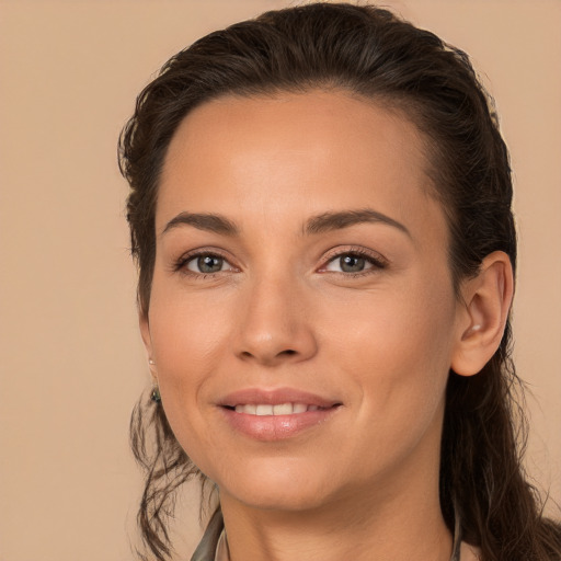 Joyful white young-adult female with long  brown hair and brown eyes