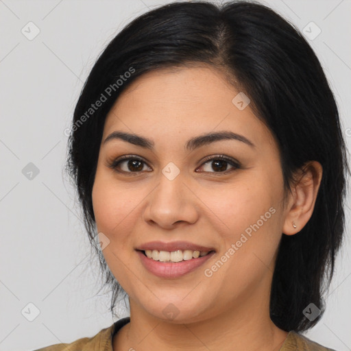 Joyful latino young-adult female with medium  brown hair and brown eyes