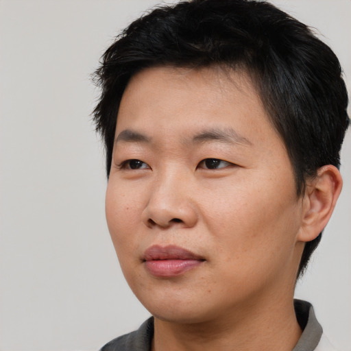 Joyful asian young-adult male with short  black hair and brown eyes
