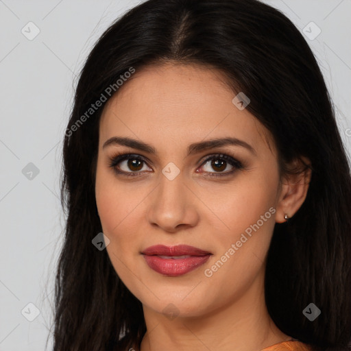 Joyful latino young-adult female with long  brown hair and brown eyes